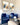 Pair of blue Tracy chairs in a living room beneath framed art