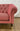 Close-up of the pink Westgate loveseat's rolled arm and turned leg