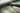 Close up of sage green plush mohair velvet upholstery fabric with soft textured folds by Black Label Home