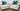 Pair of cream Bacara chairs with teal accent pillows