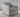Slipcovered Tracy chair in gray upholstery with a loose back cushion