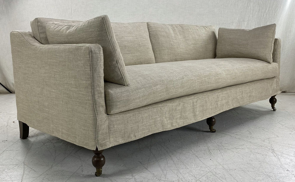 Slipcovered sofa with turned legs