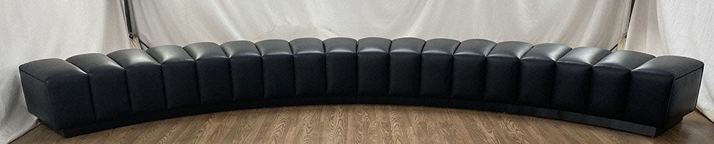 Curved channeled bench in leather
