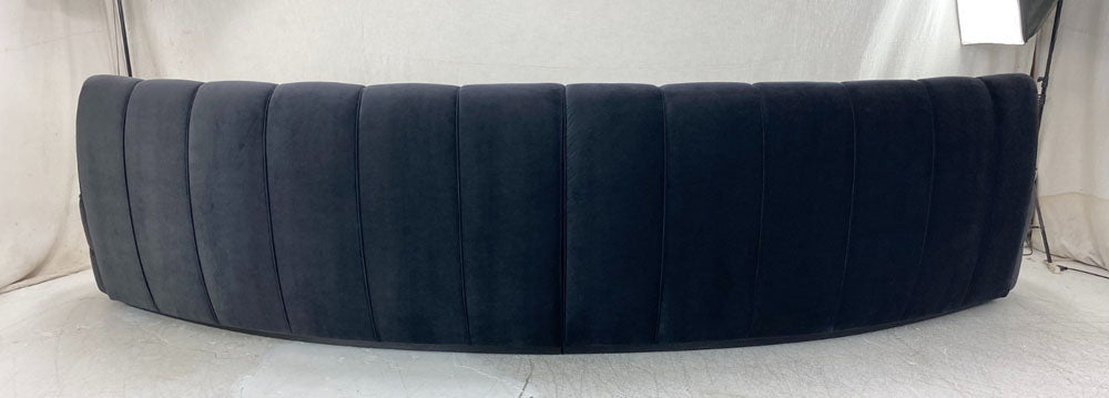 Vertically channeled curved sofa