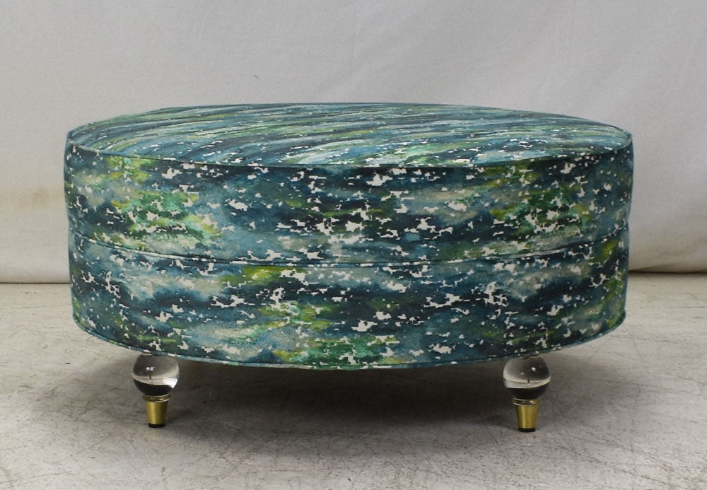 Round ottoman in COM with acrylic legs