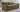 Slipcovered Lexington sofa in tan upholstery with rolled arms