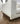 Close-up of the Sean sofa's upholstered arm and wood plinth base